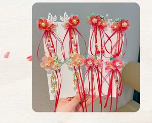 Detail of traditional Chinese hanfu hair clips with floral motifs and silk tassels