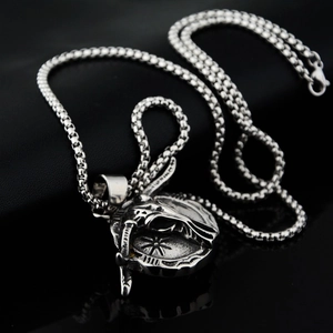 Détail du pendentif crâne d'antilope vintage sur une chaîne à mailles carrées polies
