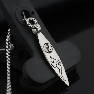 Titanium steel surfboard pendant necklace with Tai Chi symbol and tribal carvings
