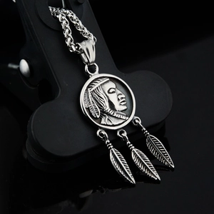 Close-up of vintage titanium steel necklace with Indian coin and three feather charms