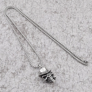 Punk style skull pendant necklace with top hat and pipe on a steel box chain