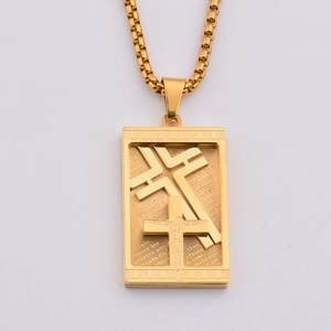 Close-up of gold stainless steel rectangular pendant with cross design and Lord's Prayer