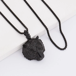 Macro shot of 3D embossed black tiger head pendant with matte stainless steel box chain
