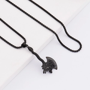 Macro shot of a black dragon axe pendant with detailed scales and heavy stainless steel square chain