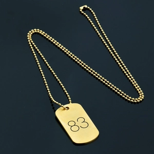 Hip hop style gold ball chain necklace with number 83 tag pendant on black background
