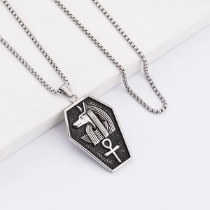 Hip hop stainless steel Ankh cross necklace featuring Anubis pendant on a white pedestal