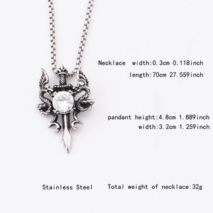 Detail of gothic sword pendant with snakes, wings, and clear crystal on box chain