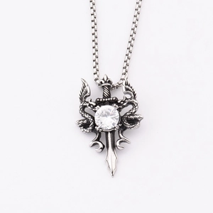 Macro detail of gothic sword and snake pendant with large clear zircon on box chain