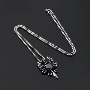 Detailed macro view of hip hop sword pendant with black stone and double snake texture