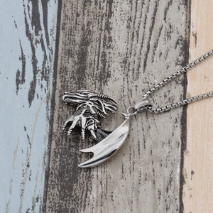 Detailed close-up of dragon head pendant necklace with box chain in vintage silver