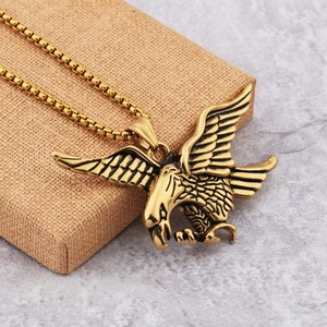 Hip hop style gold falcon pendant necklace with detailed eagle wings and box chain