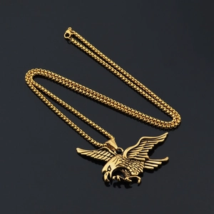 Detailed close-up of a soaring golden eagle pendant with intricate feathers on a box chain