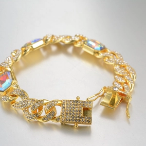 Golden Cuban link bracelet with multicolored rectangular stones and iced-out diamond clasp