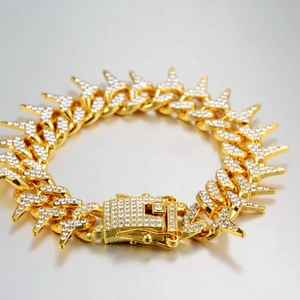 Macro shot of gold hip hop Cuban bracelet featuring iced-out zircon and lightning bolt clasp