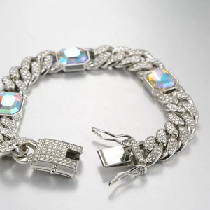 Macro shot of silver Cuban link bracelet with iridescent zircon stones and iced out details