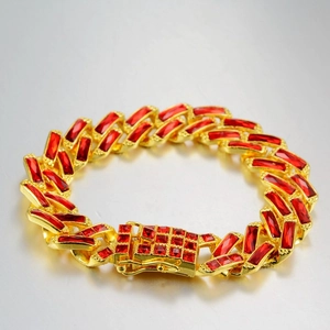 Macro detail of gold Cuban chain bracelet featuring red baguette-cut zircon stones