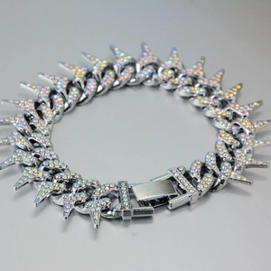 Detail of silver Cuban link bracelet with iced-out AB zircons and sharp thorn accents