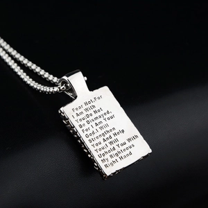 Detailed macro view of silver square pendant necklace with engraved Bible verse on box chain
