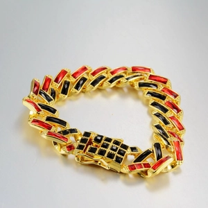 Macro shot of Cuban chain link bracelet with red and black stones and pavé set clasp