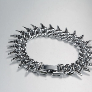 Macro shot of silver hip hop cuban chain with black zircon pavé and gothic spikes
