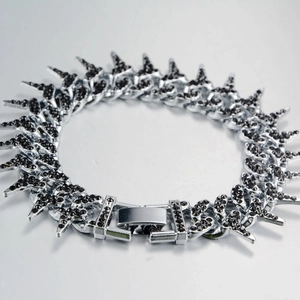 Macro shot of hip hop thorn bracelet with black zircons and silver punk star links
