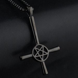 Gothic black metal inverted cross pendant with pentagram star on leather background