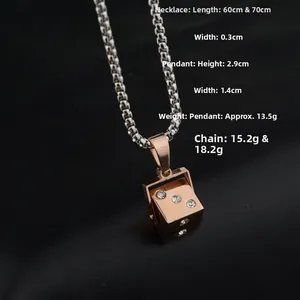 Macro view of iced out dice pendant necklace with dimensions 2.9cm x 1.4cm on leather background