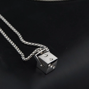 Polished silver square dice pendant necklace with white crystals on black leather base