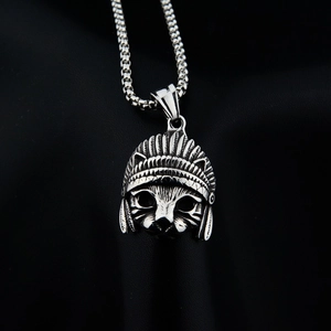 Detailed macro of vintage silver Elvis cat pendant with chief headdress and box chain