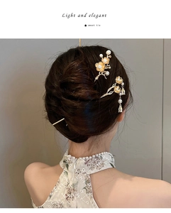 Detailed view of elegant Chinese lotus hairpins with pearls and tassels on braided hair