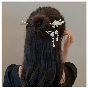 Detail showing vintage silver plum blossom hairpins with pearls and tassels in a bun
