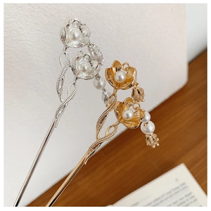 Macro detail of tulip flower hair pins with pearls and textured metal finish