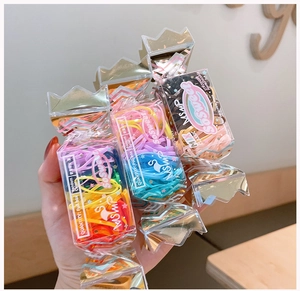 Close-up of colorful high-elastic hair ties in a cute candy-shaped storage box with crown lid