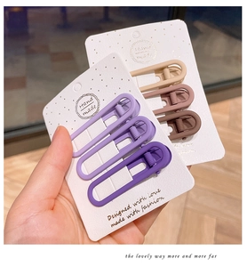 Close-up of matte Morandi color alloy hair clips in purple and brown sets on display card