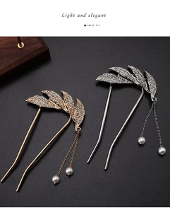 U-shaped hair pin featuring rhinestone leaves and elegant pearl tassel drop detail