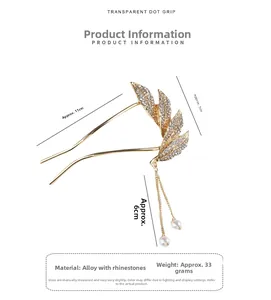 Macro detail of golden leaf hair pin with sparkling rhinestones and pearl tassels