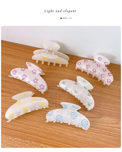 Set of six translucent frosted white acrylic hair claws with diverse colorful prints