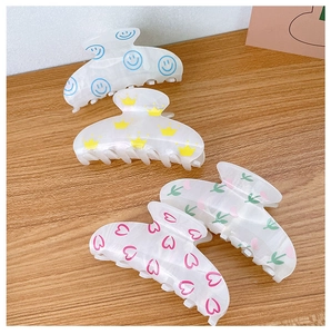 Set of four large acrylic hair claws with cute floral and smile patterns