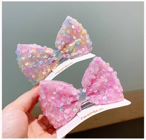 Detail of pink sequin butterfly hair clips for girls on a fashion display card