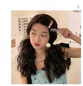 Creative comb-shaped mini hair clips with floral patterns worn on a side hairstyle
