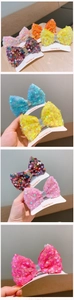 Detail view of colorful sequin bow hair clips with soft fabric lining and metal clips