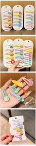 Macro shot of colorful cartoon fruit and animal resin hair clips for girls in a set