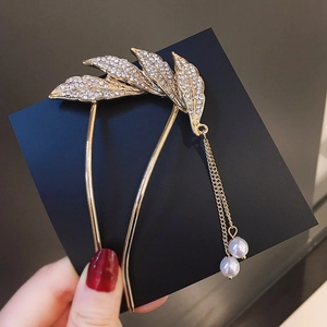 Elegant gold leaf hair pin with sparkling rhinestones and dangling pearl tassels