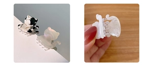 Detalle de mini pinzas de pelo con forma de gato en acetato blanco y de vaca