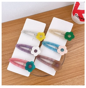 Set of 6 colorful acetate flower hair clips in macaron colors on a display card