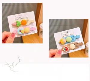 Detail showing colorful ice cream and donut hair clips on a white display card