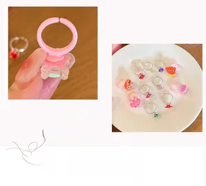 Detail of adjustable cartoon princess rings with pink rabbits and colorful gemstones