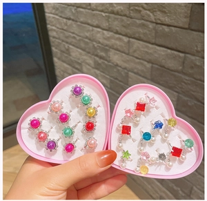 Pink heart shaped box with assorted children's gemstone rings and jewelry set