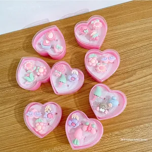 Detail of colorful matte resin rings for girls in heart-shaped pink gift boxes