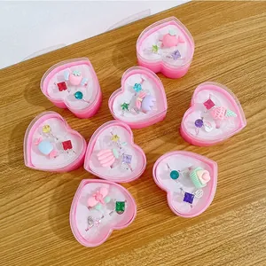 Detailed close-up of heart-shaped gift boxes with cute cartoon gemstone rings for girls